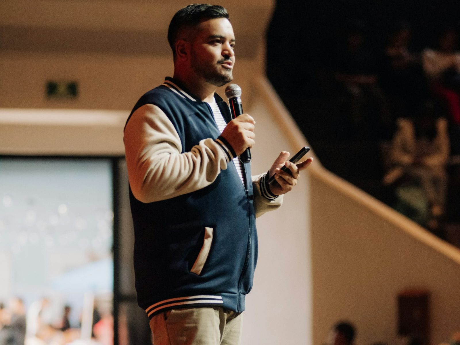 An entrepreneur on stage with a microphone, mid-talk